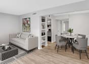 Thumbnail 3 of 9 - A living room with a white couch and a dining table with grey chairs.