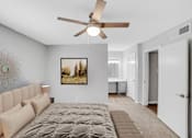 Thumbnail 6 of 9 - A bedroom with a large bed and a ceiling fan.