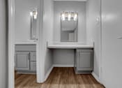 Thumbnail 9 of 9 - A white bathroom with a vanity and a mirror.