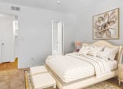 Thumbnail 3 of 5 - A bedroom with a large bed and a painting on the wall.
