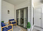 Thumbnail 13 of 20 - a patio with two chairs and a sliding glass door
