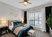 Thumbnail 19 of 20 - a bedroom with a bed and a ceiling fan