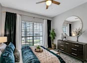 Thumbnail 18 of 20 - a bedroom with a bed and a ceiling fan
