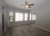 Thumbnail 3 of 59 - an empty living room with a ceiling fan and windows