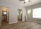 Thumbnail 6 of 59 - a living room with a wooden floor and a ceiling fan