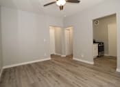 Thumbnail 7 of 59 - a living room with white walls and a ceiling fan