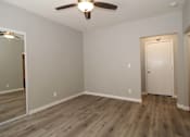 Thumbnail 8 of 59 - a empty room with wood floors and a ceiling fan