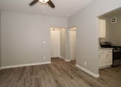 Thumbnail 9 of 59 - a living room with white walls and a ceiling fan