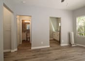 Thumbnail 10 of 59 - a renovated living room with a wooden floor and a bathroom