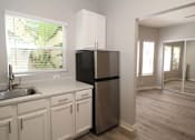 Thumbnail 15 of 59 - a kitchen with white cabinets and a stainless steel refrigerator
