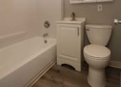 Thumbnail 17 of 59 - a bathroom with a toilet and a tub and a mirror