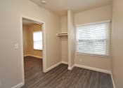 Thumbnail 32 of 59 - a bedroom with a closet and a window and wood flooring