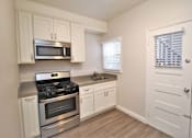 Thumbnail 34 of 59 - a kitchen with stainless steel appliances and white cabinets