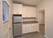 Thumbnail 35 of 59 - a kitchen with white cabinets and a stainless steel refrigerator