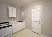 Thumbnail 42 of 59 - a kitchen with a stove and a sink and a refrigerator