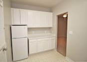 Thumbnail 43 of 59 - a kitchen with white cabinets and a refrigerator