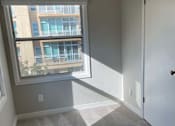 Thumbnail 45 of 59 - an empty bedroom with a window and carpeted floor