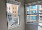 Thumbnail 46 of 59 - a living room with two windows and a carpeted floor