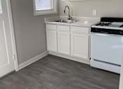Thumbnail 47 of 59 - a kitchen with white cabinets and a stove and a sink