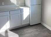 Thumbnail 48 of 59 - a kitchen with white cabinets and a refrigerator