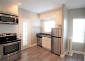 Thumbnail 53 of 59 - a kitchen with stainless steel appliances and white cabinets