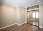 Thumbnail 56 of 59 - a living room with a mirror and hardwood floors