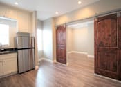 Thumbnail 59 of 59 - a kitchen with a stainless steel refrigerator and a wooden door