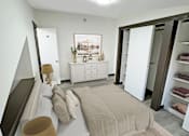Thumbnail 8 of 17 - A bedroom with a bed, dresser, and wardrobe.