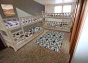 Thumbnail 10 of 17 - a bunk bed room with two bunk beds and a rug