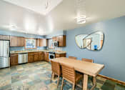 Thumbnail 4 of 28 - A kitchen with a table and chairs.
