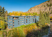 Thumbnail 24 of 28 - A large building with many windows is situated on a hillside.