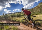 Thumbnail 27 of 28 - a man riding a bike on a dirt road  biking biking trails in your backyard