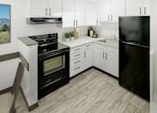 Thumbnail 3 of 17 - A modern kitchen with black appliances and white cabinets.