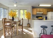 Thumbnail 12 of 28 - a kitchen and dining room with a table and chairs