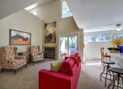 Thumbnail 10 of 28 - a living room with a couch and chairs and a fireplace