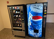 Thumbnail 4 of 24 - two vending machines next to each other next to a soda bottle