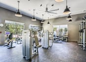 Thumbnail 11 of 19 - A gym with a variety of equipment including treadmills, weights, and exercise machines.at Infinity on Yorktown, Dallas, 75208