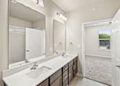 Thumbnail 15 of 19 - an empty bathroom with two sinks and a mirror at Creekside at Grand Prairie, Grand Prairie, Texas, 75052