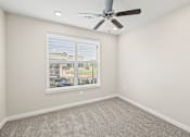 Thumbnail 16 of 19 - an empty room with a window and a ceiling fan at Creekside at Grand Prairie, Texas, 75052