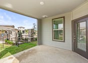 Thumbnail 19 of 19 - the front porch of a home with a patio and a fence at Creekside at Grand Prairie, Grand Prairie, Texas