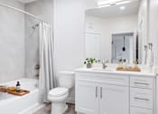 Thumbnail 16 of 17 - A white bathroom with a toilet, sink, and bathtub at 901 Rendon, Burleson, TX