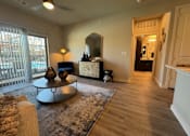Thumbnail 21 of 25 - A living room with a sofa, a coffee table, and a mirror at Arden at Corinth, Corinth, TX