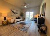Thumbnail 24 of 25 - A living room with a white couch, a round table, and a rug at Arden at Corinth, Corinth, TX, 76210