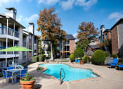 Thumbnail 2 of 30 - our apartments have a large pool and patio with chairs and umbrellas at Infinity on the Mark, Dallas, Texas