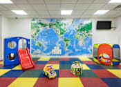 Thumbnail 20 of 24 - A playroom with a world map on the wall and a slide.