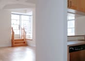 Thumbnail 11 of 24 - A kitchen with wooden cabinets and a stove top oven.at 21 West, New York
