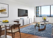 Thumbnail 4 of 12 - A modern living room with a flat screen TV mounted on the wall.at Carnegie Mews, New York, 10019