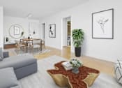 Thumbnail 1 of 12 - A living room with a grey sofa, a coffee table with a vase of flowers, a potted plant, and pictures on the wall at The Caldwell Apartments, New York, NY, 10028