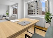 Thumbnail 6 of 12 - A laptop is on a wooden desk in a room with a window at The Caldwell Apartments, New York, 10028