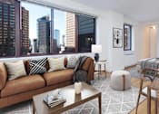 Thumbnail 15 of 17 - A modern living room with a brown sofa and a wooden coffee table at The Ellington Apartments, New York